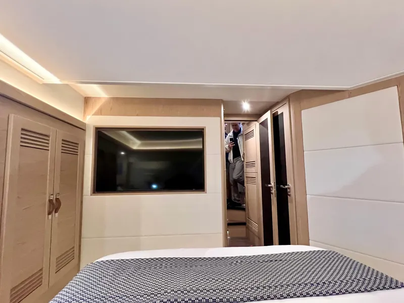 Slide: The Image of 2025 Beneteau Swift Trawler 54 bedroom interior with modern design and ample storage. - 13