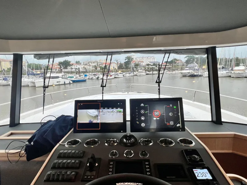 Slide: The Image of Helm station of 2025 Beneteau Swift Trawler 54 with marina view. - 3