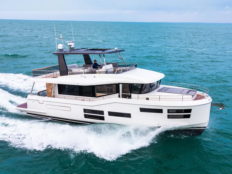 Slide: The Image of 2025 Beneteau Grand Trawler 62 cruising on open sea, showcasing sleek design and luxury features. - 0