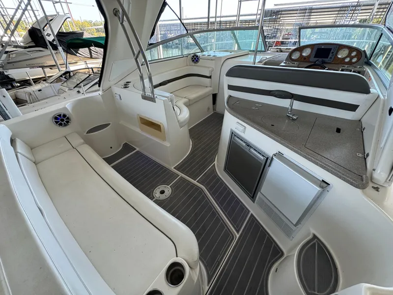 Slide: The Image of 2008 Rinker 370 boat interior with white seating and modern amenities. - 10