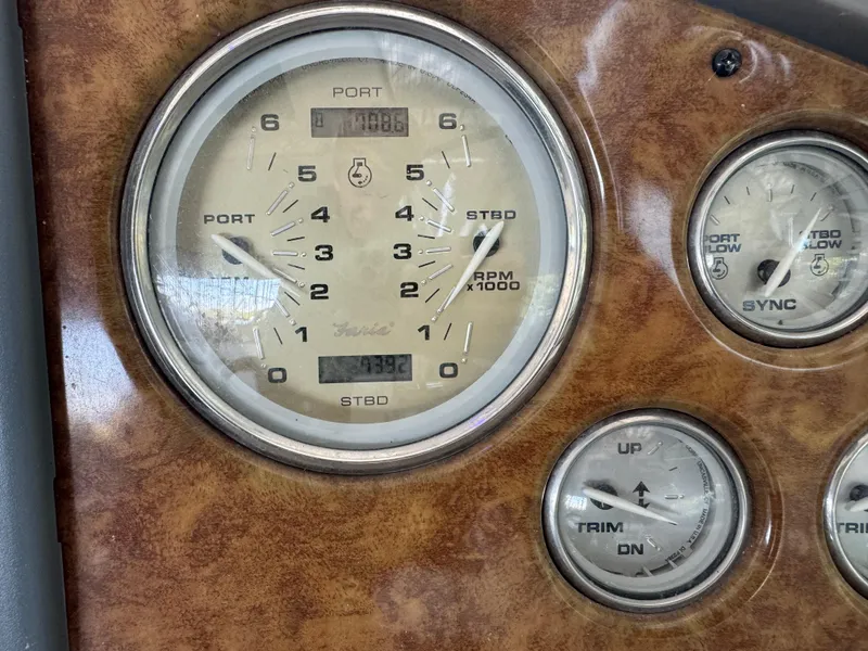 Slide: The Image of 2008 Rinker 370 boat dashboard with RPM and trim gauges. - 11