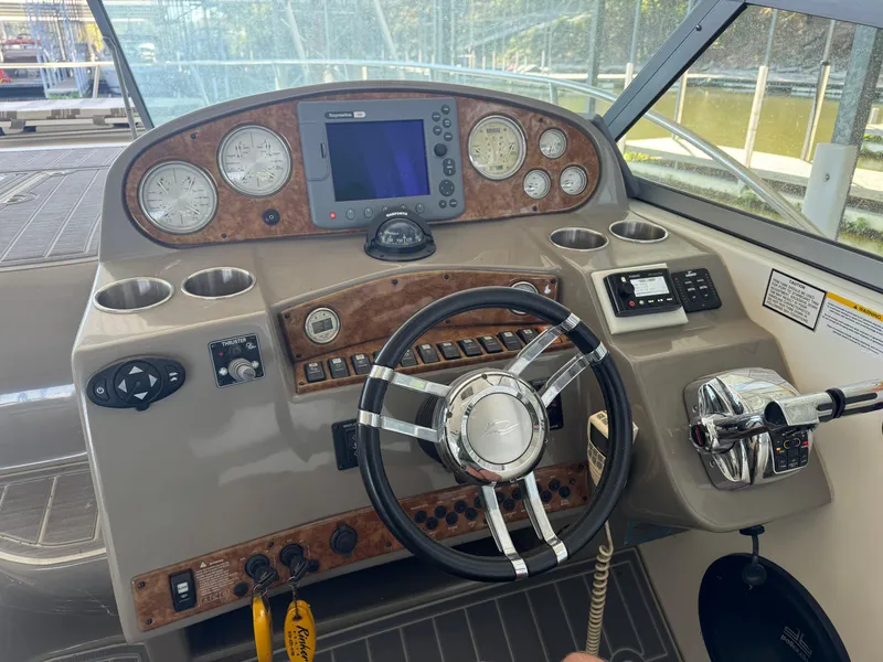 Slide: The Image of 2008 Rinker 370 boat dashboard with steering wheel and navigation instruments. - 15