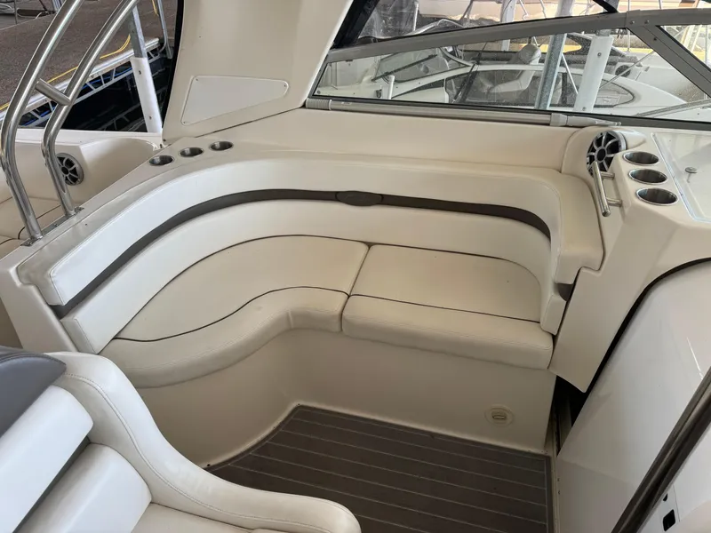 Slide: The Image of 2008 Rinker 370 boat interior with white leather seating and cup holders. - 16