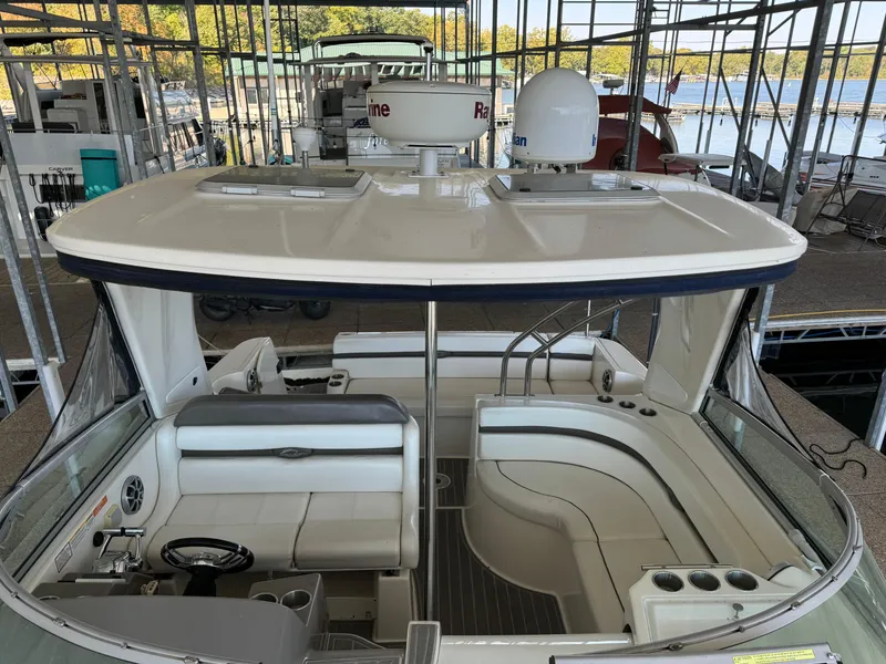Slide: The Image of 2008 Rinker 370 boat interior with seating and navigation equipment in a marina. - 18