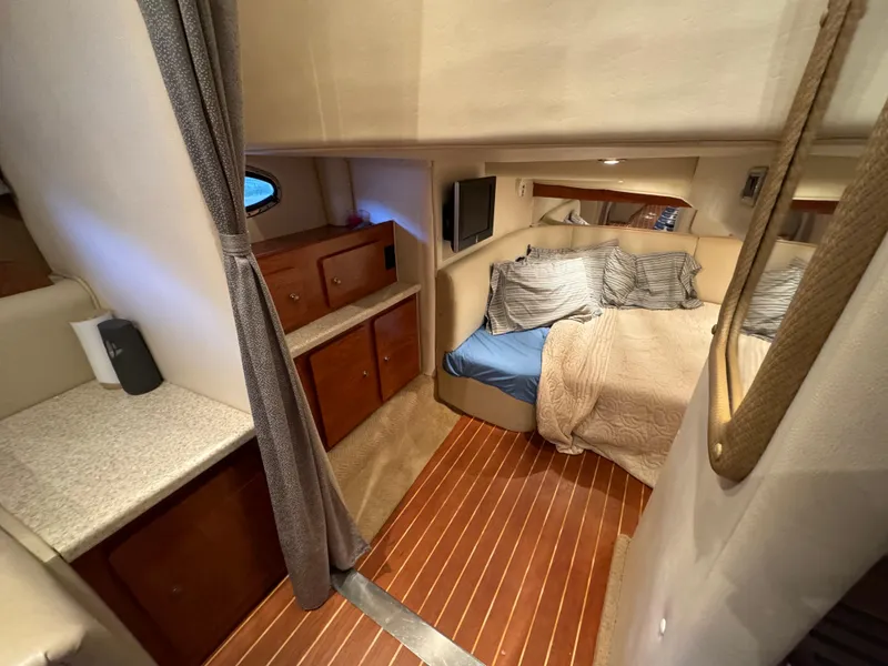 Slide: The Image of Interior of 2008 Rinker 370 boat with cozy bedroom and wooden flooring. - 23
