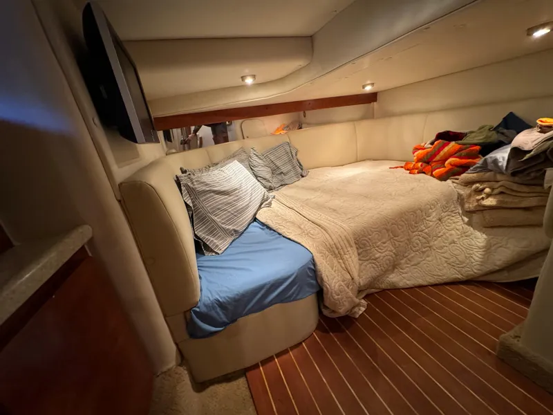 Slide: The Image of Cozy cabin interior of 2008 Rinker 370 boat with bed and pillows. - 24