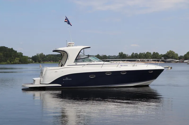 Slide: The Image of 2008 Rinker 370 boat cruising on a calm lake. - 5