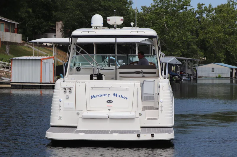 Slide: The Image of 2008 Rinker 370 boat named Memory Maker docked on a calm lake. - 7