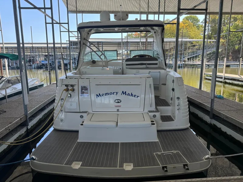 Slide: The Image of 2008 Rinker 370 boat named "Memory Maker" docked in a marina. - 9