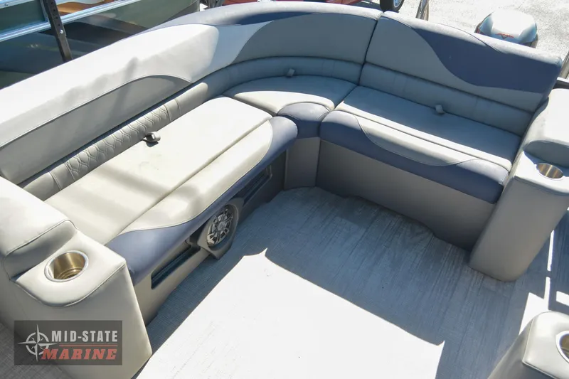 Slide: The Image of 2023 Tahoe Pontoon LTZ Elite interior seating with cup holders and storage. - 13