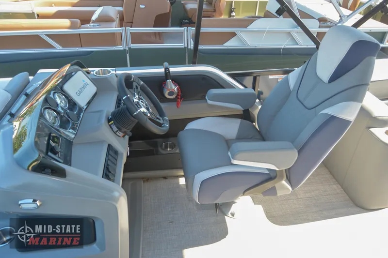 Slide: The Image of 2023 Tahoe Pontoon LTZ Elite captain's chair and helm station. - 15