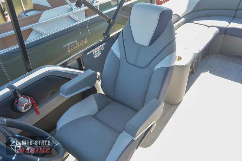 Slide: The Image of 2023 Tahoe Pontoon LTZ Elite captain's chair and helm station. - 16