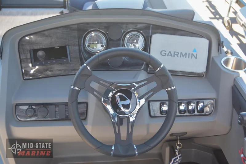 Slide: The Image of 2023 Tahoe Pontoon LTZ Elite dashboard with Garmin navigation system and steering wheel. - 17