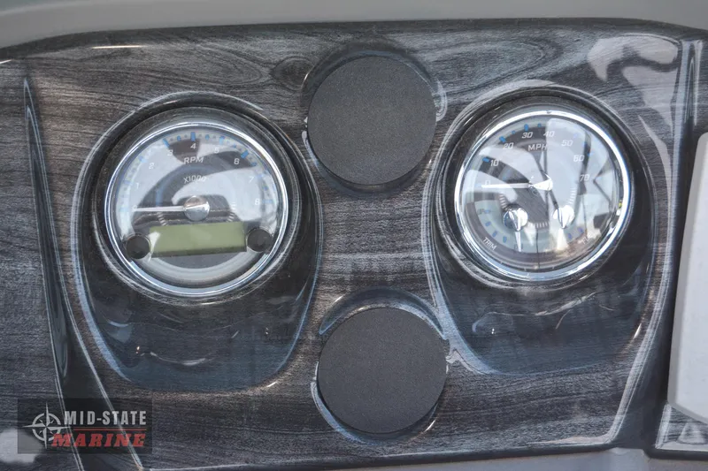 Slide: The Image of 2023 Tahoe Pontoon LTZ Elite dashboard with RPM and MPH gauges. - 18
