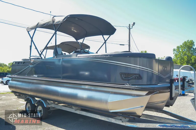 Slide: The Image of 2023 Tahoe Pontoon LTZ Elite on trailer at Mid-State Marine dealership. - 2