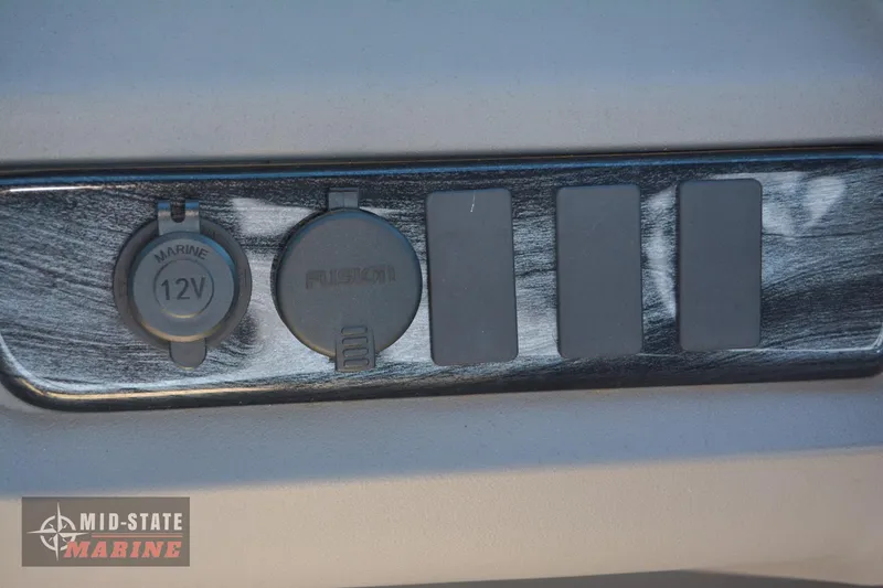 Slide: The Image of Close-up of the 2023 Tahoe Pontoon LTZ Elite dashboard with 12V and auxiliary ports. - 21