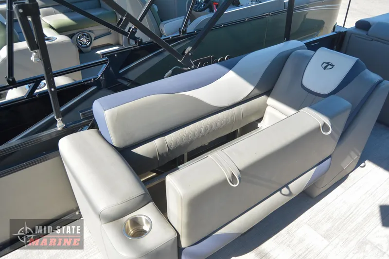 Slide: The Image of 2023 Tahoe Pontoon LTZ Elite interior seating with cup holder and armrest. - 25