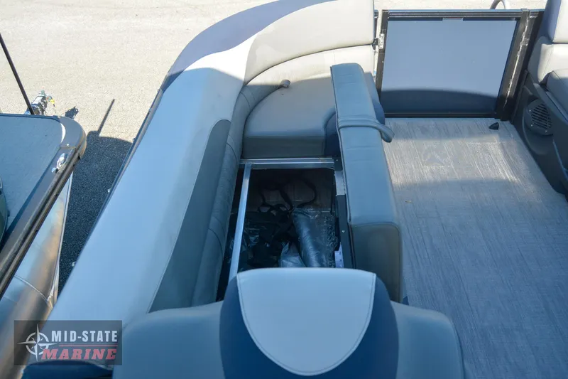 Slide: The Image of 2023 Tahoe Pontoon LTZ Elite interior with storage compartment open. - 28