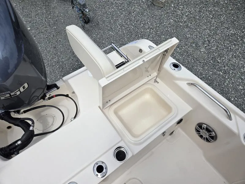 Slide: The Image of 2025 Grady-White 231 CE boat with open storage compartment and Yamaha 250 engine. - 10