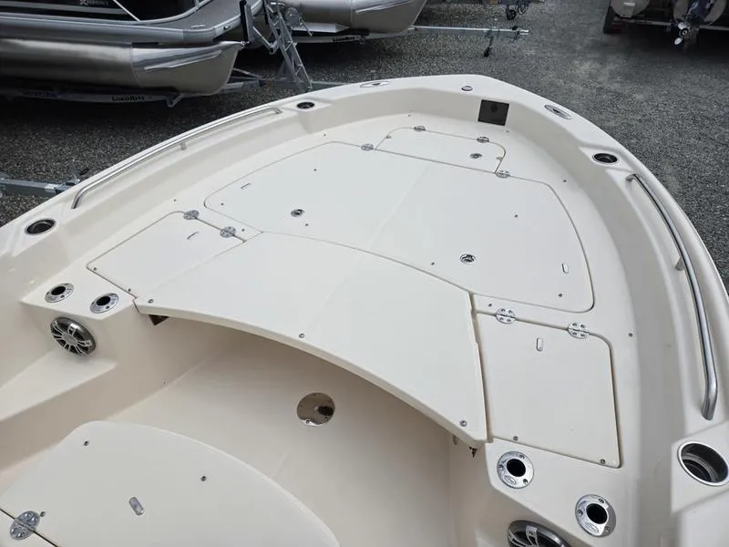Slide: The Image of 2025 Grady-White 231 CE boat deck with storage compartments and cup holders. - 15