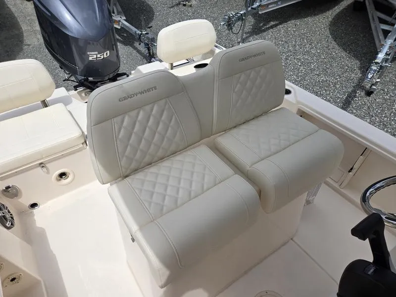 Slide: The Image of 2025 Grady-White 231 CE boat interior with cushioned seating and 250 HP engine. - 4