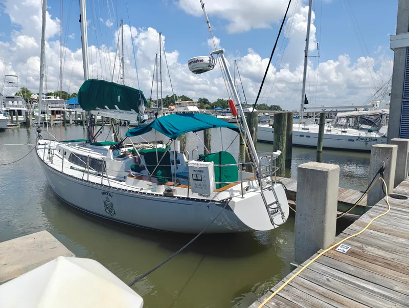 Slide: The Image of 1987 Newport MKII sailboat docked at marina under blue sky. - 0