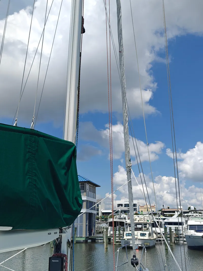 Slide: The Image of Sailboat mast and rigging at marina, Newport MKII 1987, under blue sky with clouds. - 10