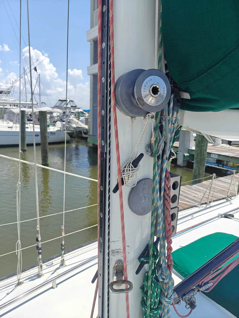 Slide: The Image of Sailboat mast with ropes and winch, Newport MKII 1987, docked at marina. - 12