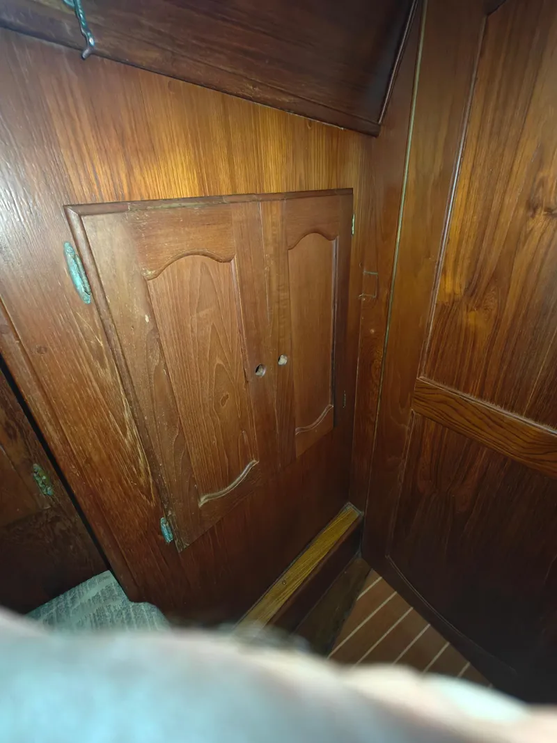 Slide: The Image of Wooden cabinet in a 1987 Newport MKII interior, showcasing classic nautical design. - 31
