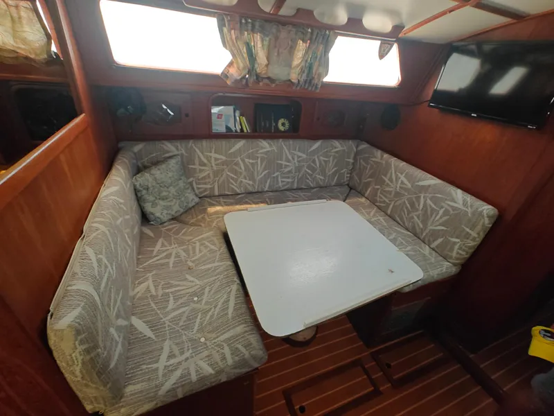 Slide: The Image of Cozy Newport MKII 1987 boat interior with cushioned seating and table. - 42