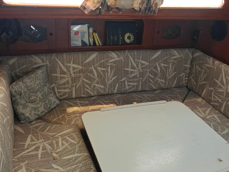 Slide: The Image of 1987 Newport MKII interior with patterned seating and a white table. - 43