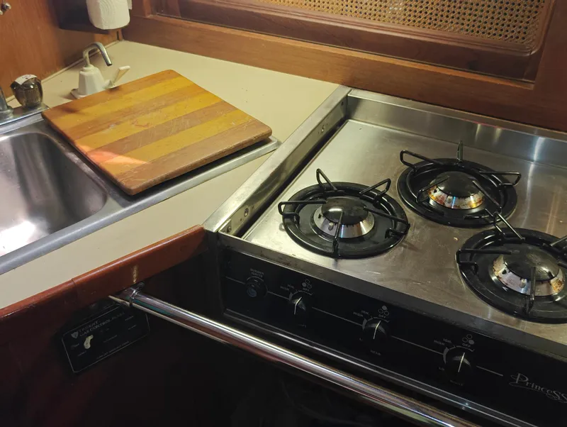 Slide: The Image of Kitchen area of a 1987 Newport MKII with stove and sink. - 47