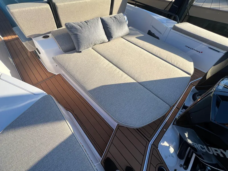 Slide: The Image of 2023 Axopar 37 Sun-Top boat with cushioned sunbathing area and teak deck. - 15