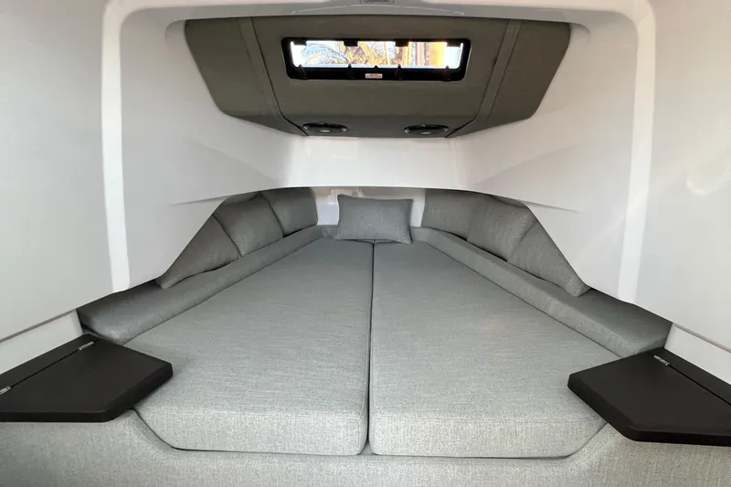 Slide: The Image of 2023 Axopar 37 Sun-Top cabin interior with grey upholstery and modern design. - 21