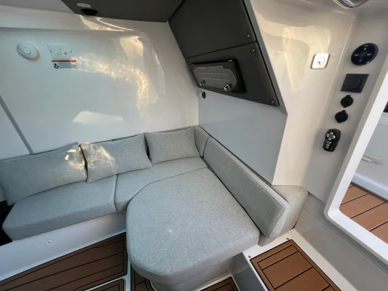 Slide: The Image of Interior seating area of 2023 Axopar 37 Sun-Top boat with grey cushions and modern design. - 24