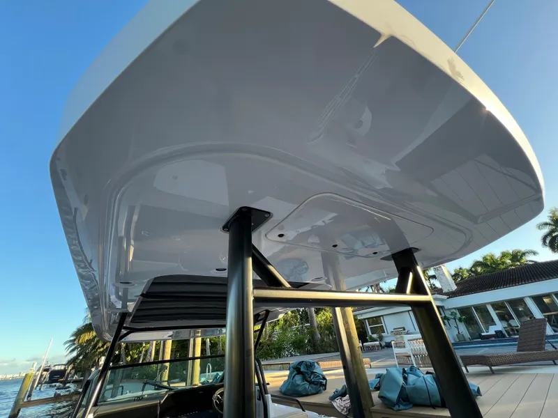 Slide: The Image of 2023 Axopar 37 Sun-Top boat docked, showcasing sleek design and sturdy structure. - 31