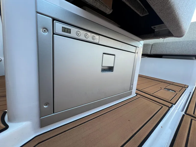 Slide: The Image of Built-in storage compartment on 2023 Axopar 37 Sun-Top boat with teak flooring. - 34