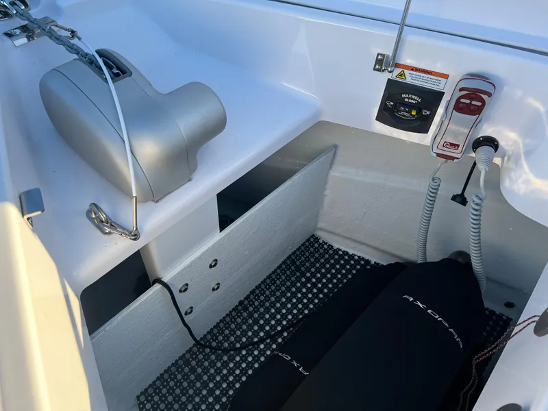 Slide: The Image of 2023 Axopar 37 Sun-Top boat interior with storage compartment and safety equipment. - 36