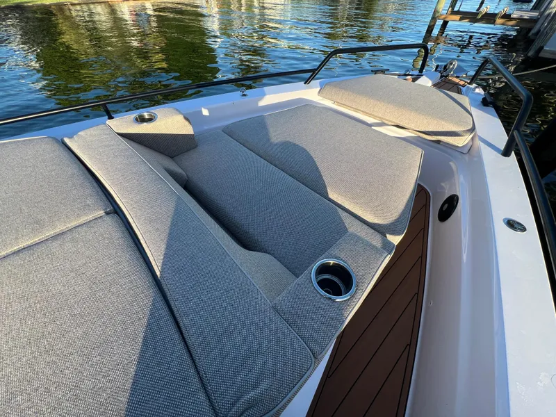 Slide: The Image of 2023 Axopar 37 Sun-Top boat with cushioned seating and cup holders on deck. - 42