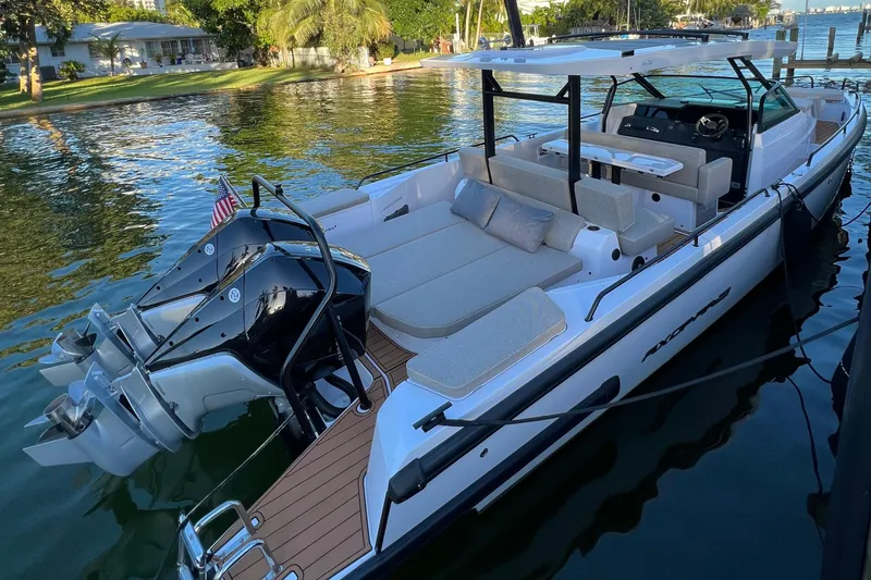 Slide: The Image of 2023 Axopar 37 Sun-Top boat docked on calm water. - 5