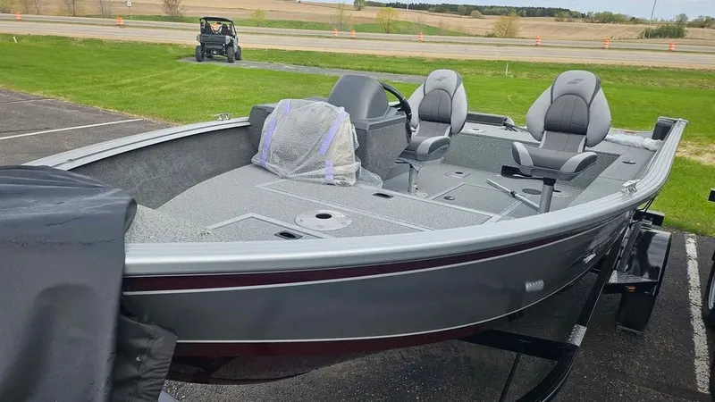 Slide: The Image of Starcraft Stealth 166 SC 2025 boat on parking lot, gray seats. - 7