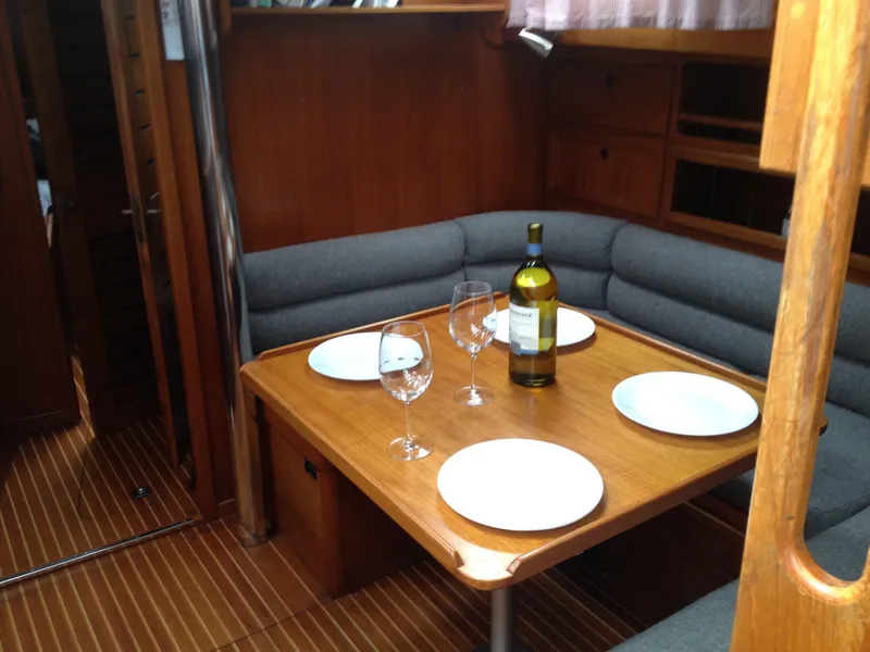 Slide: The Image of Interior of 1985 Nauticat 38 sailboat with dining table set for four. - 34