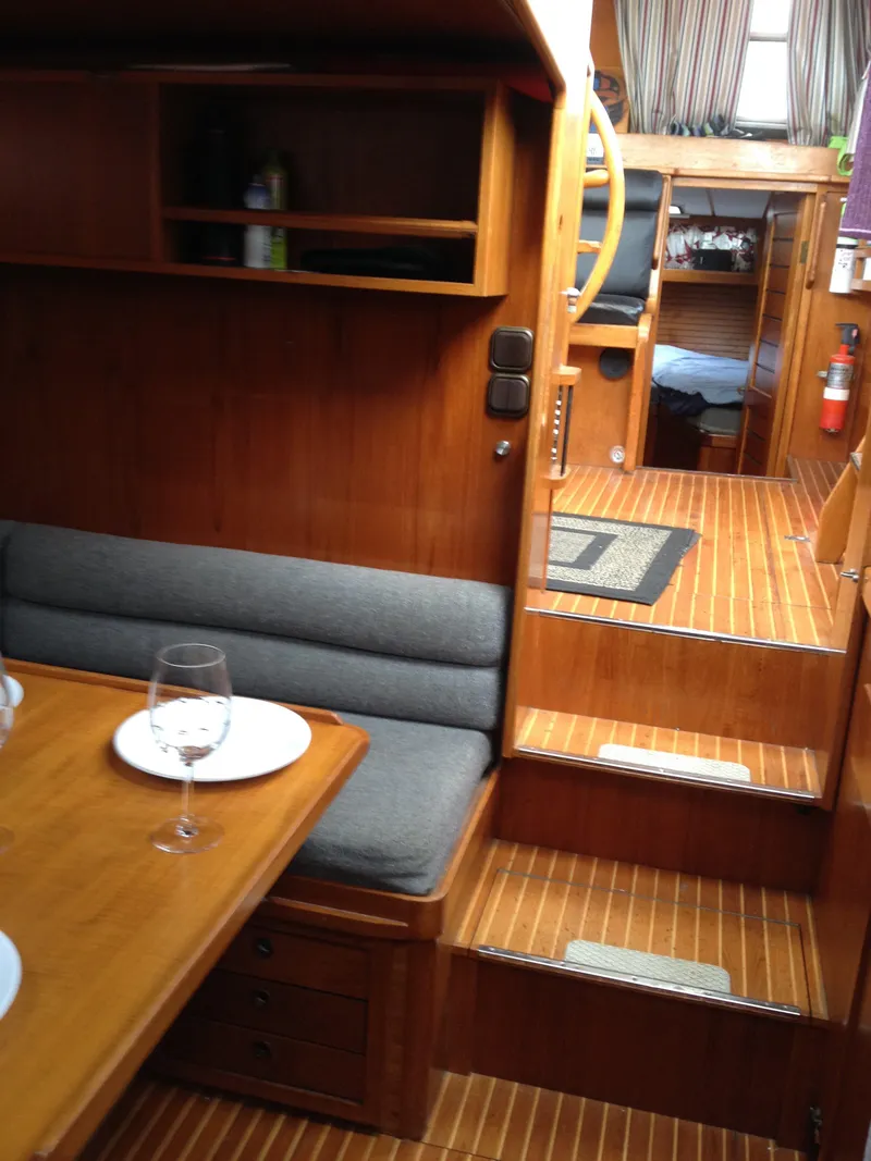 Slide: The Image of Interior of 1985 Nauticat 38 sailboat with wooden finish and cozy seating area. - 36