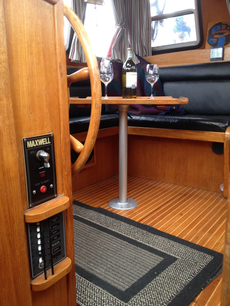Slide: The Image of Interior of 1985 Nauticat 38 sailboat with dining area and wine setup. - 37