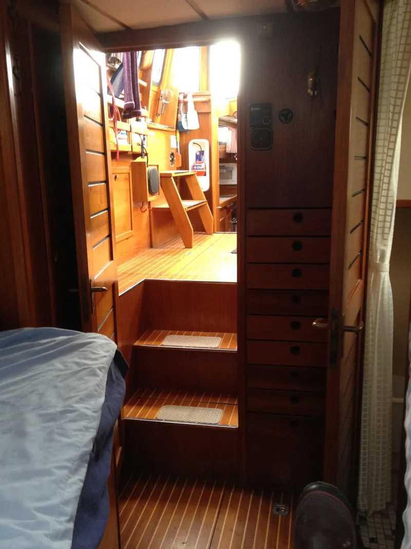 Slide: The Image of Interior of 1985 Nauticat 38 sailboat with wooden stairs and cabinetry. - 49