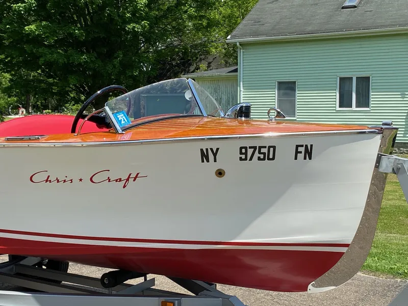 The Image of 1948 Chris-Craft Sportsman boat on trailer, displaying registration number NY 9750 FN. - 0