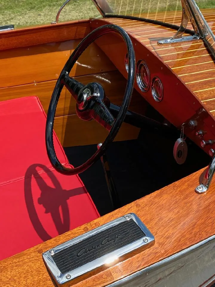 Slide: The Image of 1948 Chris-Craft Sportsman boat interior with red seats and wooden dashboard. - 2