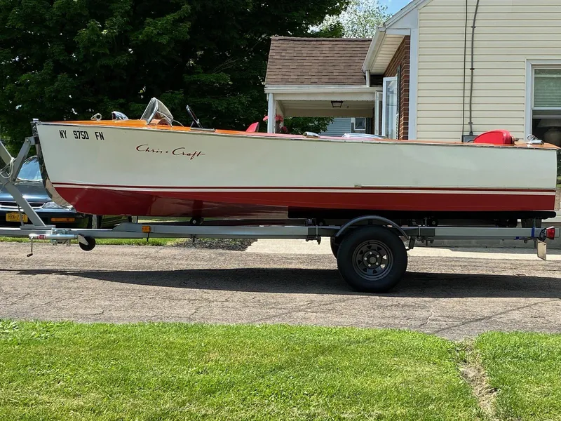 Slide: The Image of 1948 Chris-Craft Sportsman boat on trailer, parked in residential driveway. - 4