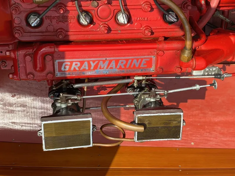 Slide: The Image of 1948 Chris-Craft Sportsman engine with Graymarine components, featuring dual carburetors and red detailing. - 6