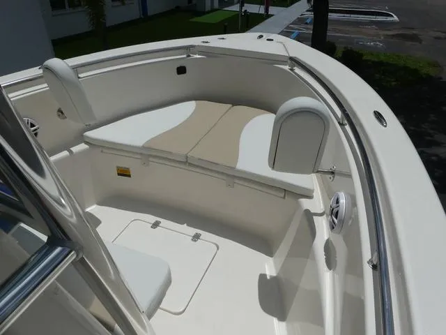 Slide: The Image of 2025 Bulls Bay 230CC boat interior with cushioned seating and storage compartments. - 11